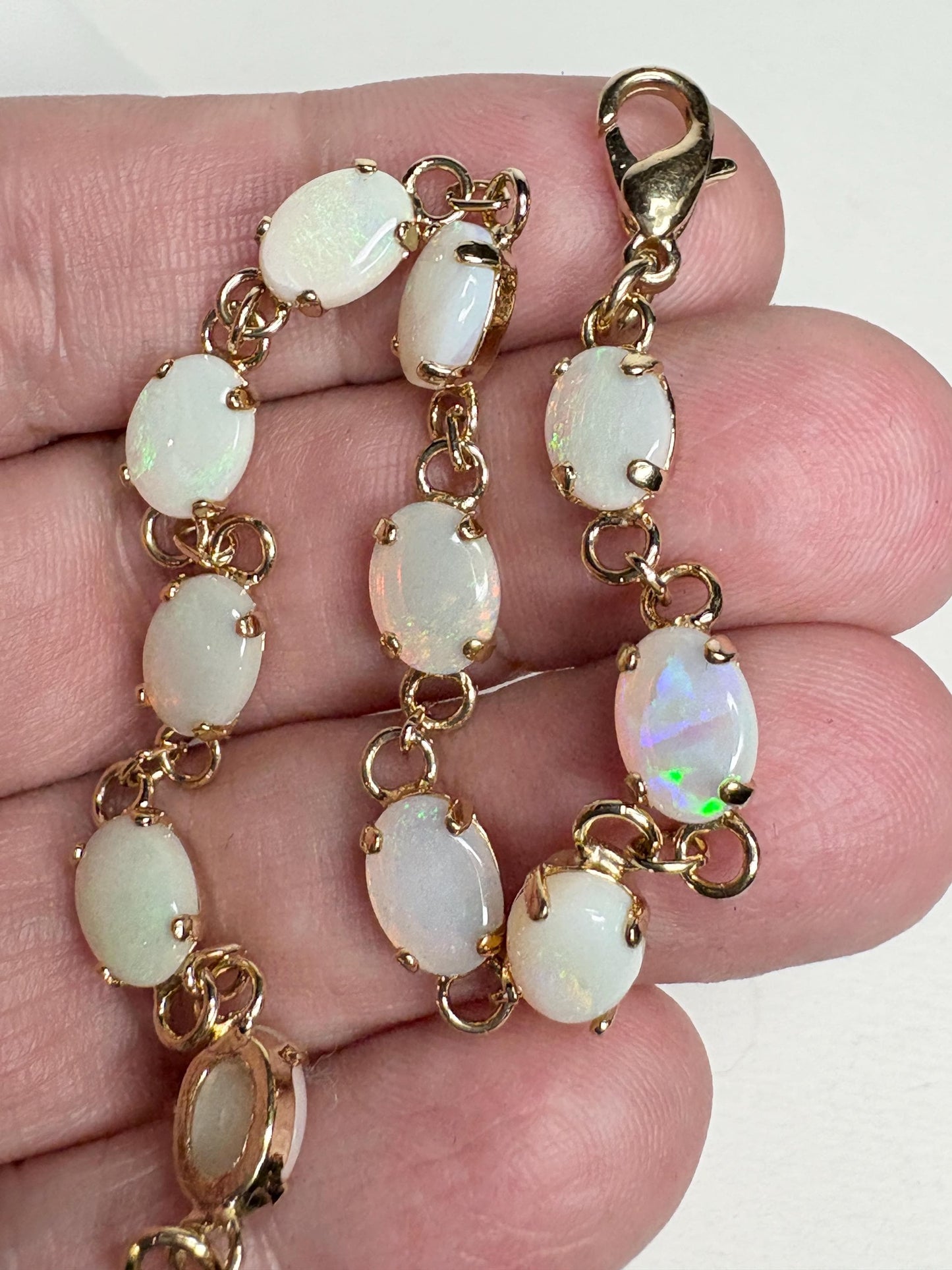 Gold plated bracelet with 11 oval natural Australian opals.