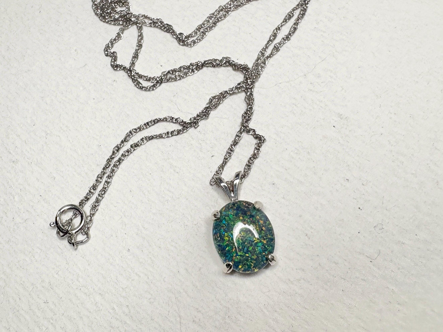 Sterling silver necklace with an oval Australian opal triplet solitaire pendant.