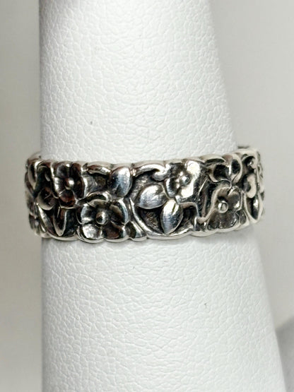 Sterling silver eternity band ring with a forget-me-not floral design.