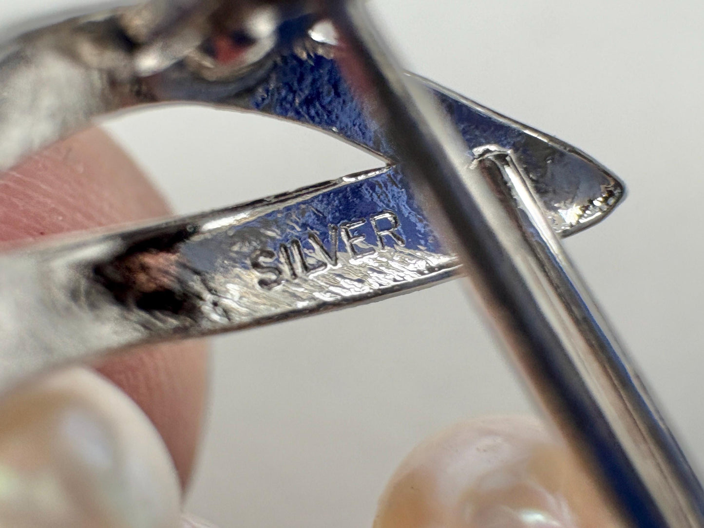 Sterling silver brooch with Akoya cultured pearls and "SILVER" stamp.