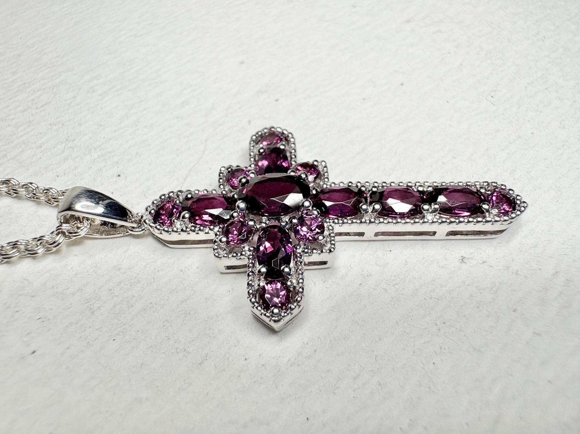 Sterling silver cross pendant necklace with rhodolite garnets.