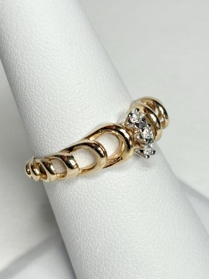 Vintage 14k gold ring with ribbon loops and three small diamonds.