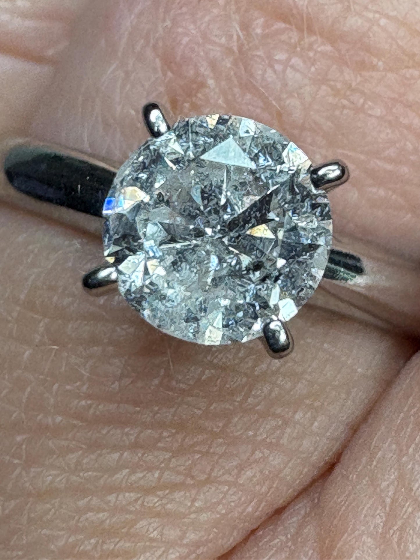 A 1ct round natural diamond solitaire ring in solid 10k white gold.