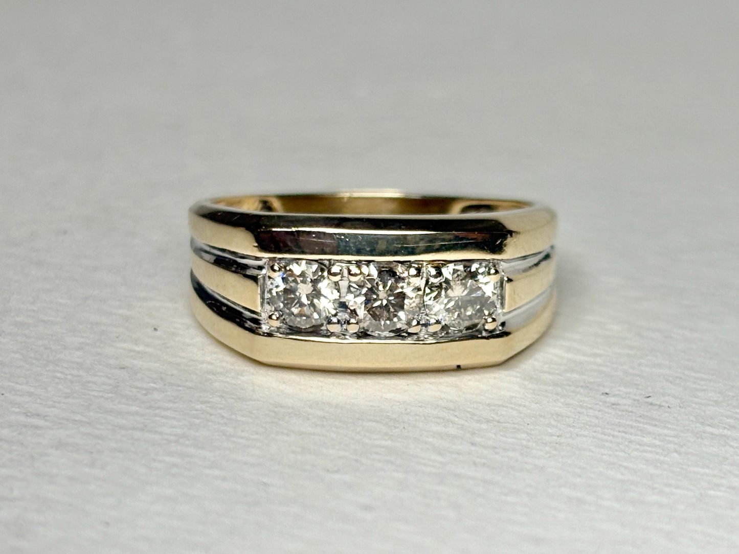 Men's 14k gold band ring with three champagne diamonds.