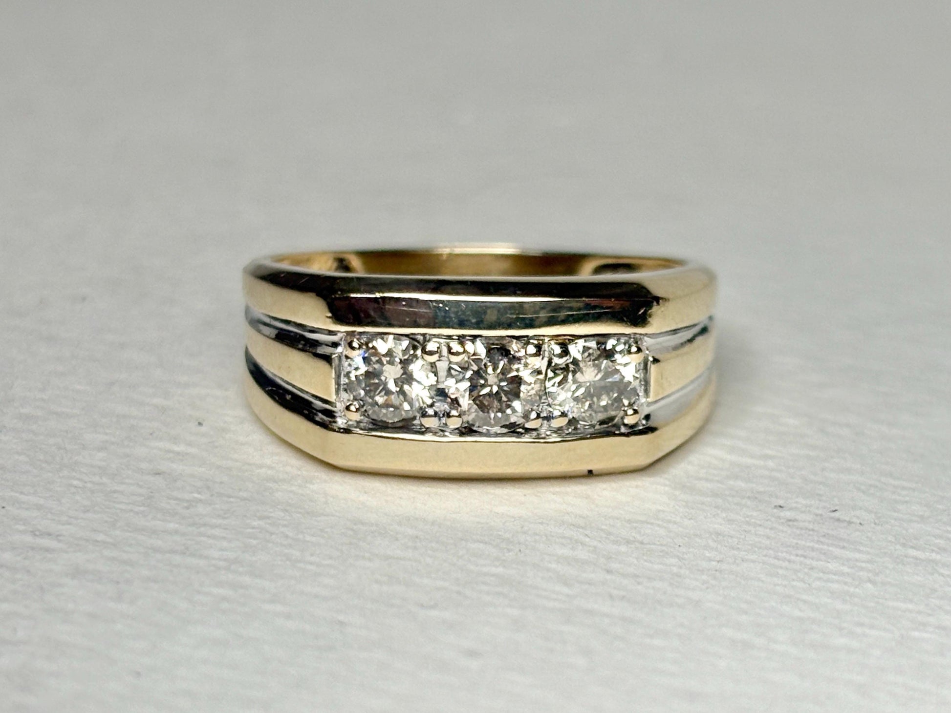 Men's 14k gold band ring with three champagne diamonds.