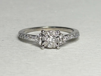A 14k white gold ring with a squared diamond cluster center and diamond accents.