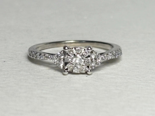 A 14k white gold ring with a squared diamond cluster center and diamond accents.