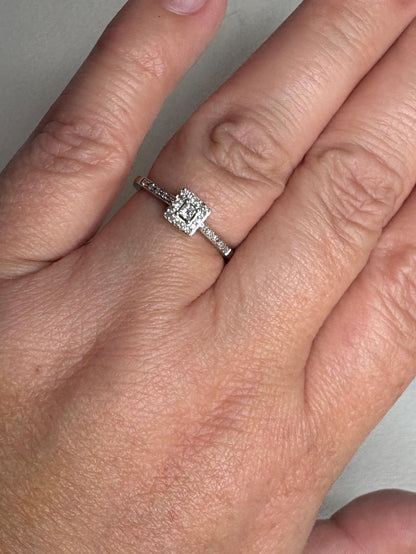 A princess cut diamond halo ring in 10k white gold.