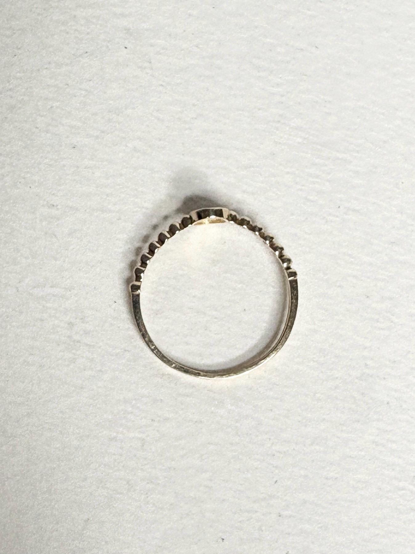 Dainty 14k yellow gold ring with a beaded band and pave-set oval stones.