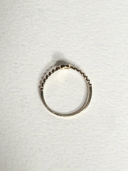 Dainty 14k yellow gold ring with a beaded band and pave-set oval stones.