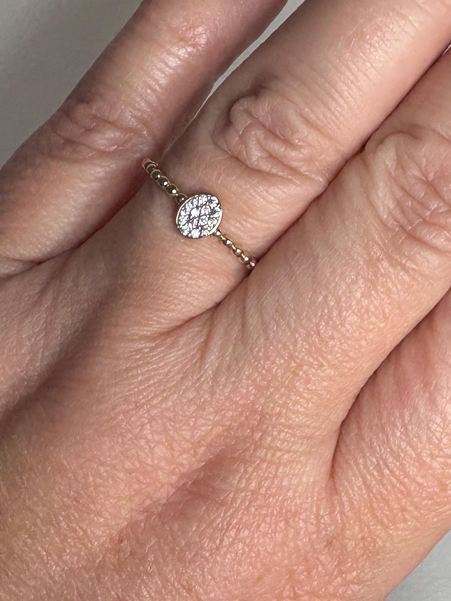 Dainty oval crystal ring with a beaded band in solid 14k yellow gold.