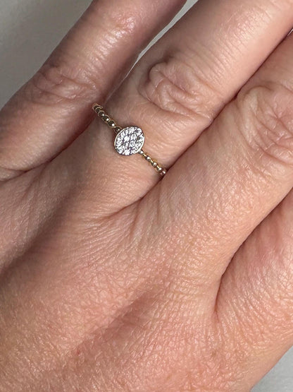 Dainty oval crystal ring with a beaded band in solid 14k yellow gold.