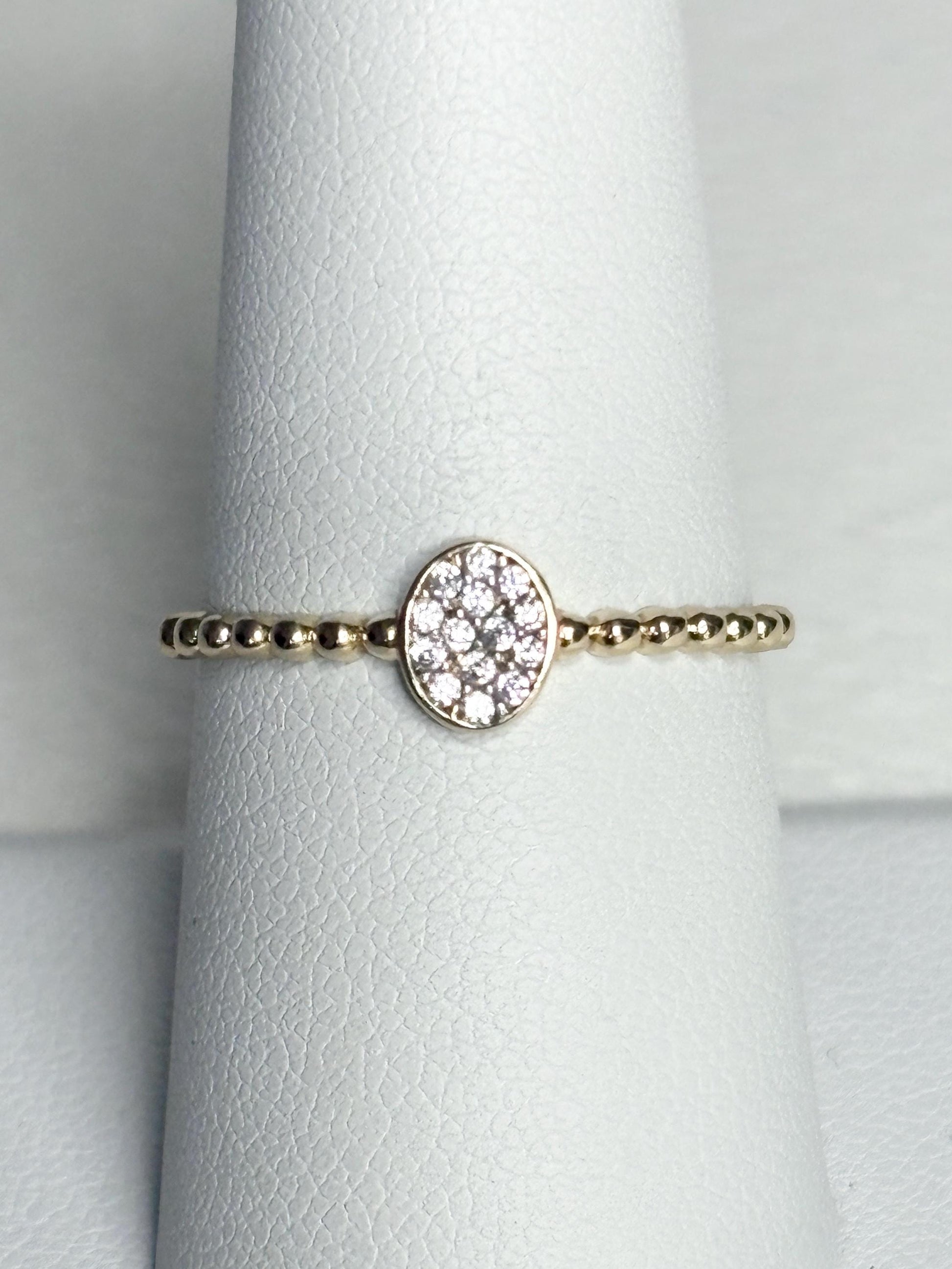 Dainty 14k gold ring with a beaded band and an oval pave-set crystal cluster.