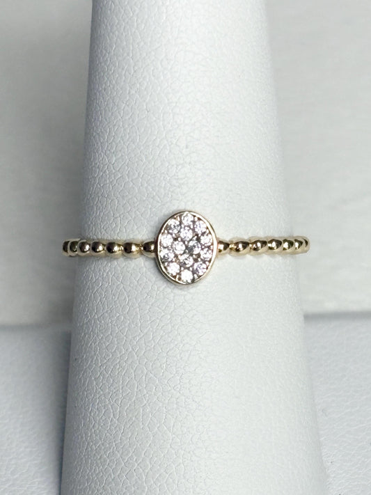 Dainty 14k gold ring with a beaded band and an oval pave-set crystal cluster.
