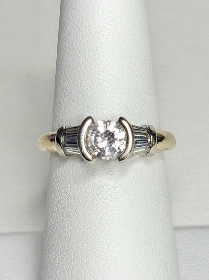 14k gold ring with a round diamond and baguette diamonds.
