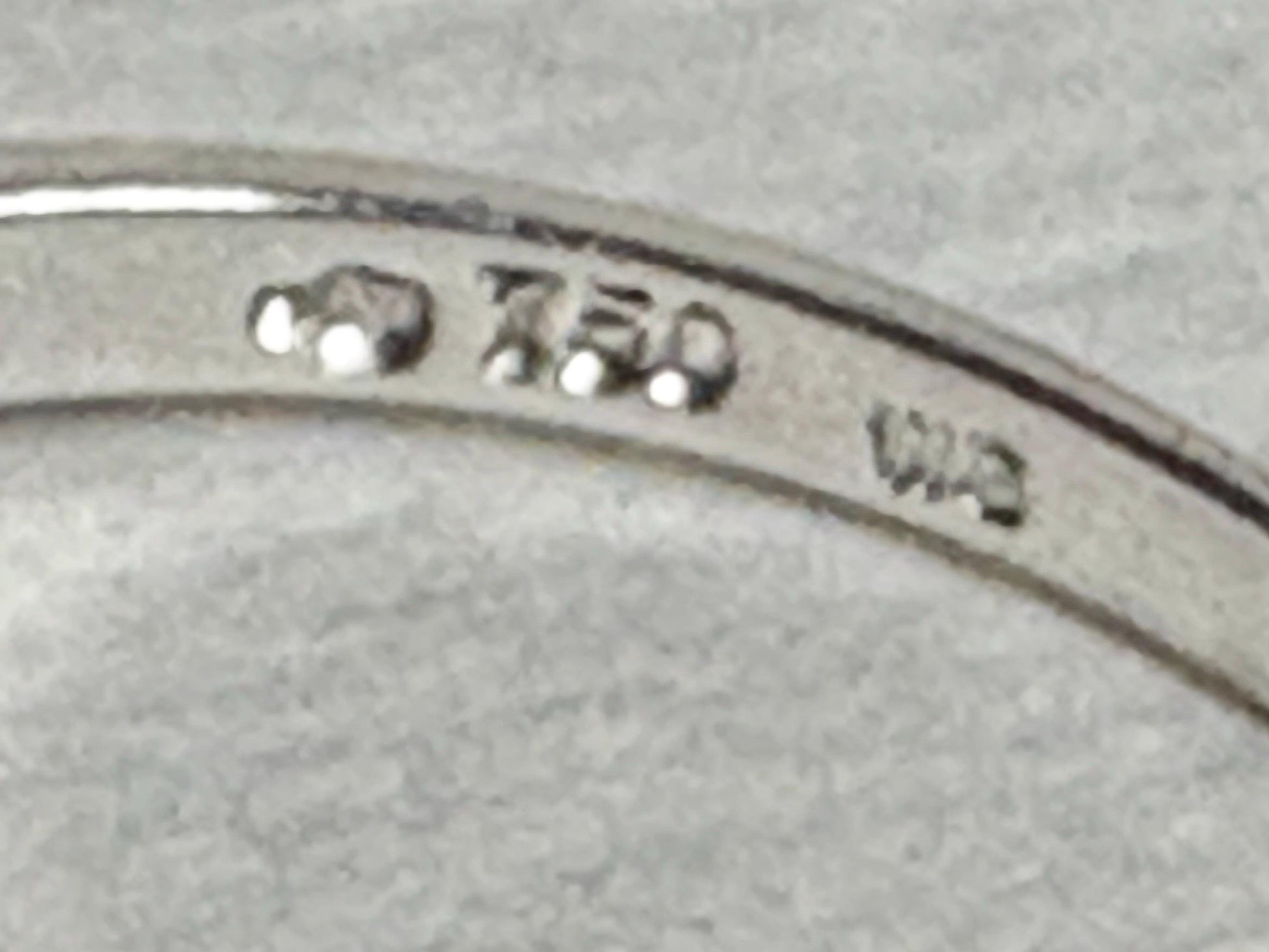 18k white gold band ring with five Akoya pearls and "750" hallmark.