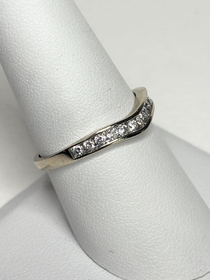 Contoured 14k white gold wedding band with channel-set diamonds.