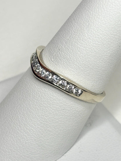 Contoured 14k white gold wedding band with channel-set diamonds.