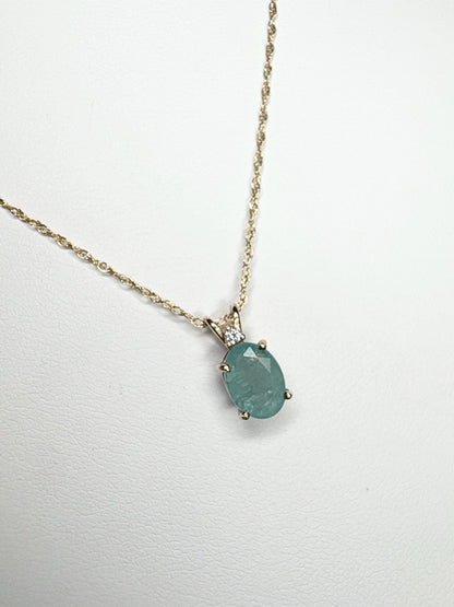 14k yellow gold necklace with oval grandidierite and diamond pendant.