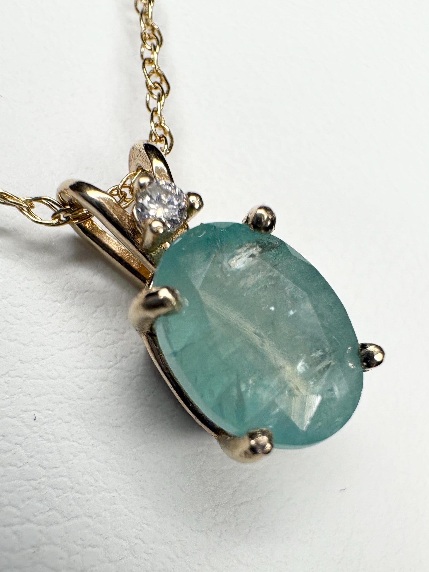 14k gold pendant necklace with oval grandidierite and diamond.