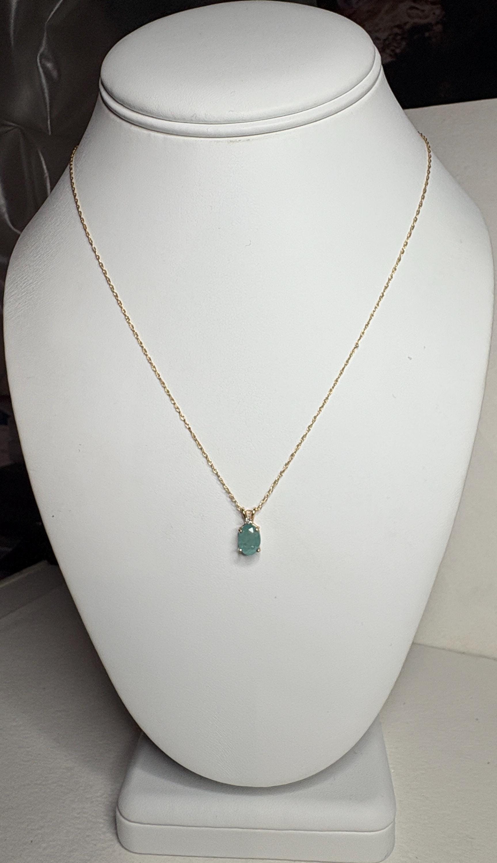 14k yellow gold necklace with an oval grandidierite and diamond pendant.