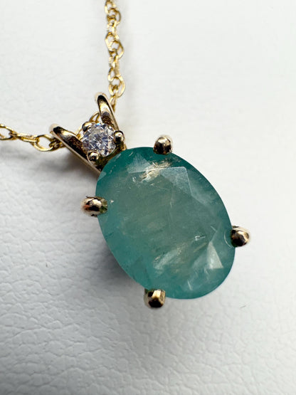14k gold pendant necklace with oval grandidierite and diamond.