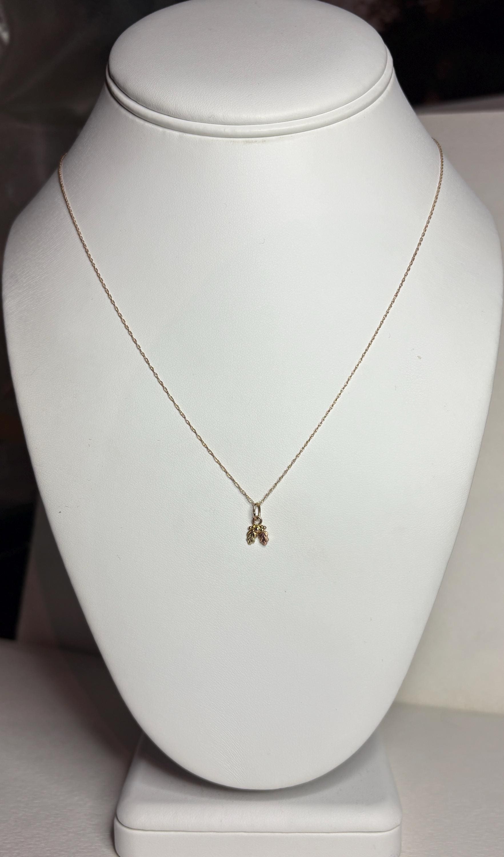 Dainty tiny Black Hills Gold pendant necklace in solid 10k gold on an 18-inch chain.