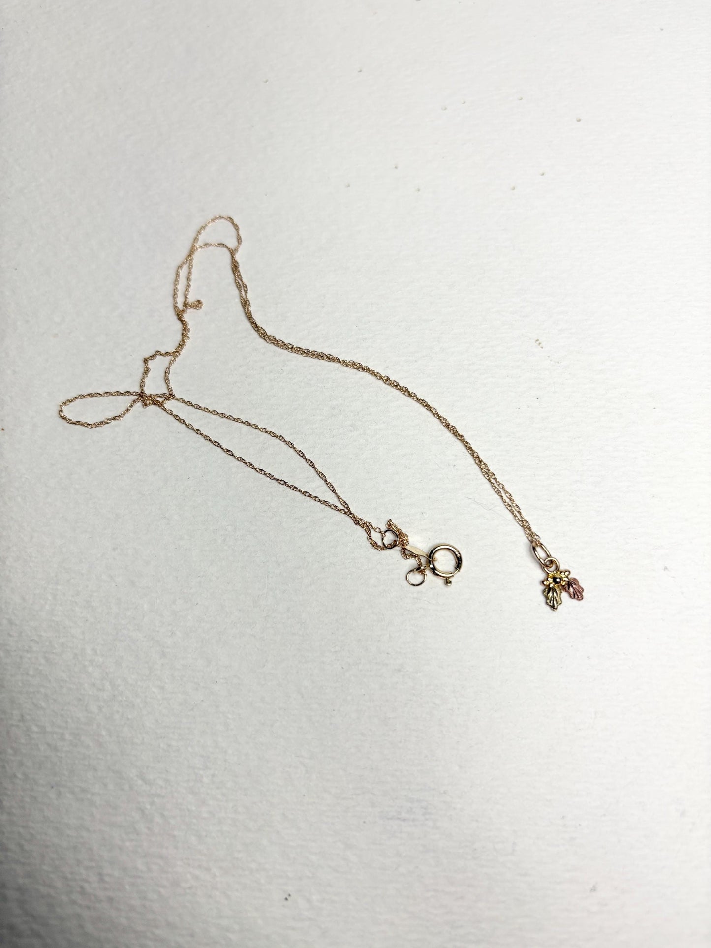 Dainty Black Hills Gold pendant necklace with three leaves on an 18-inch 10k gold chain.