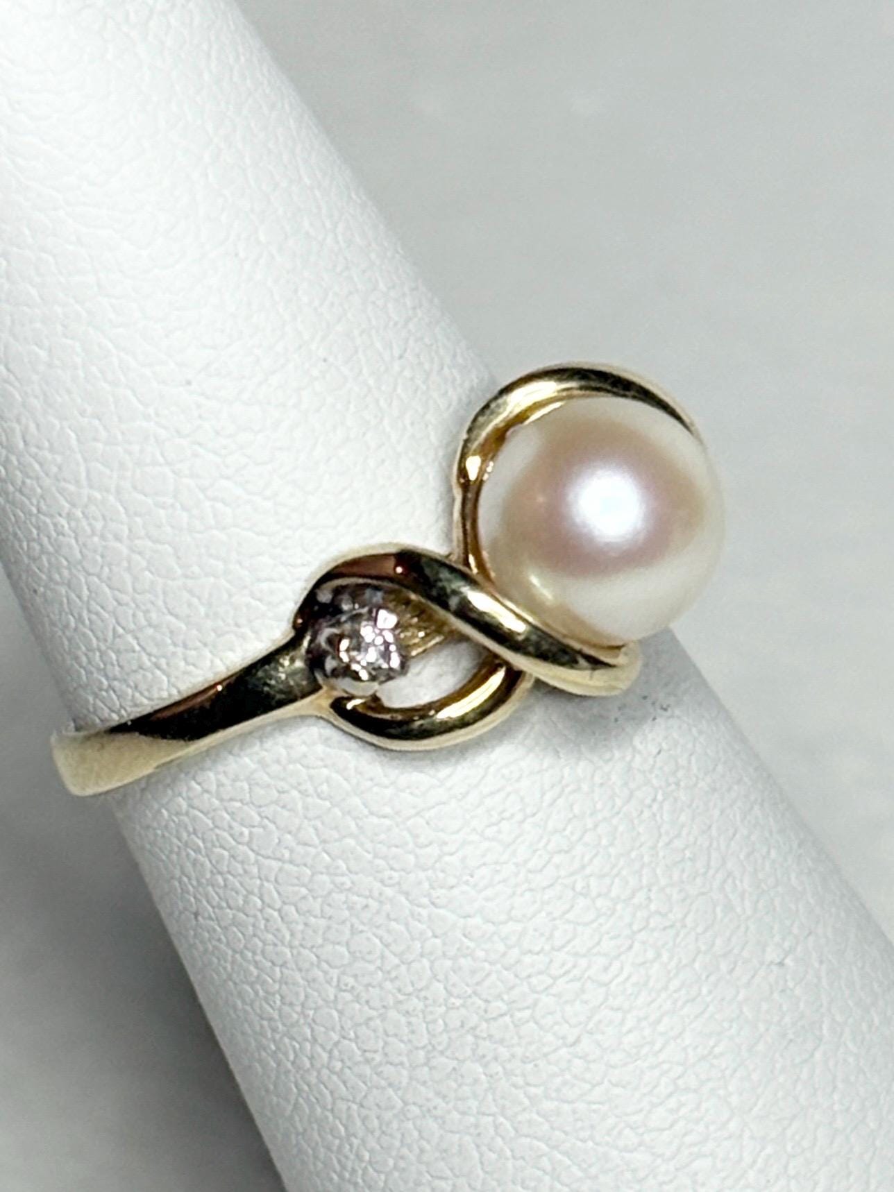 10k gold ring with a pearl and two diamonds.