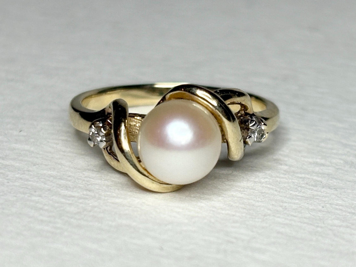 10k gold ring with a pearl and two diamonds.