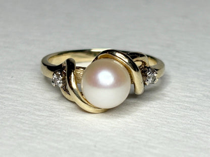 10k gold ring with a pearl and two diamonds.