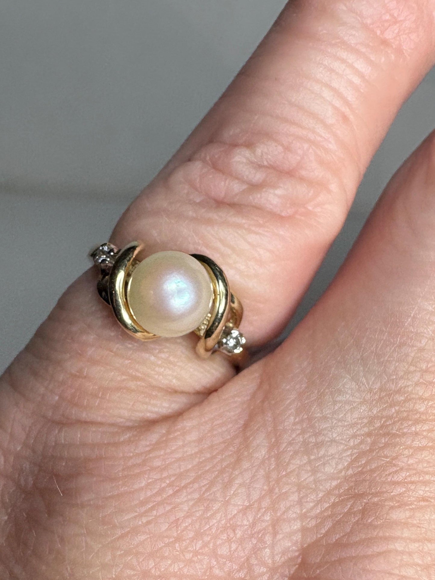 10k gold ring with a pearl and two diamonds.