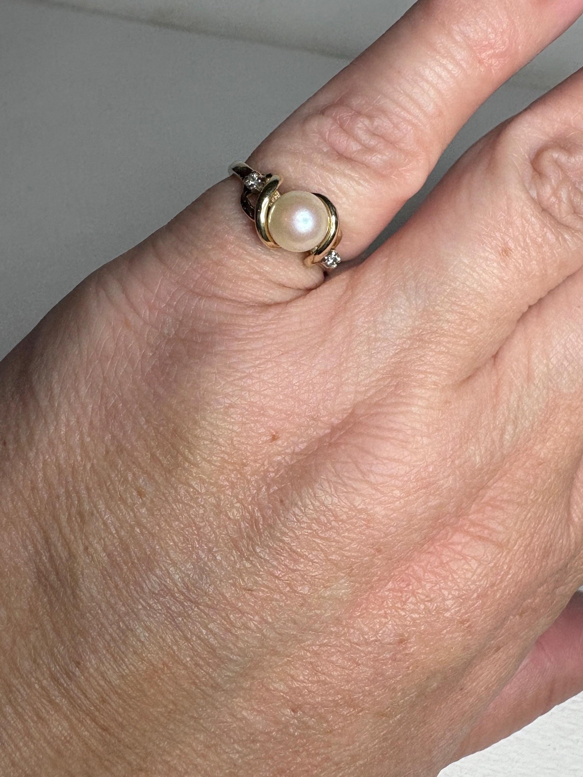 10k gold ring with a pearl and two diamonds.