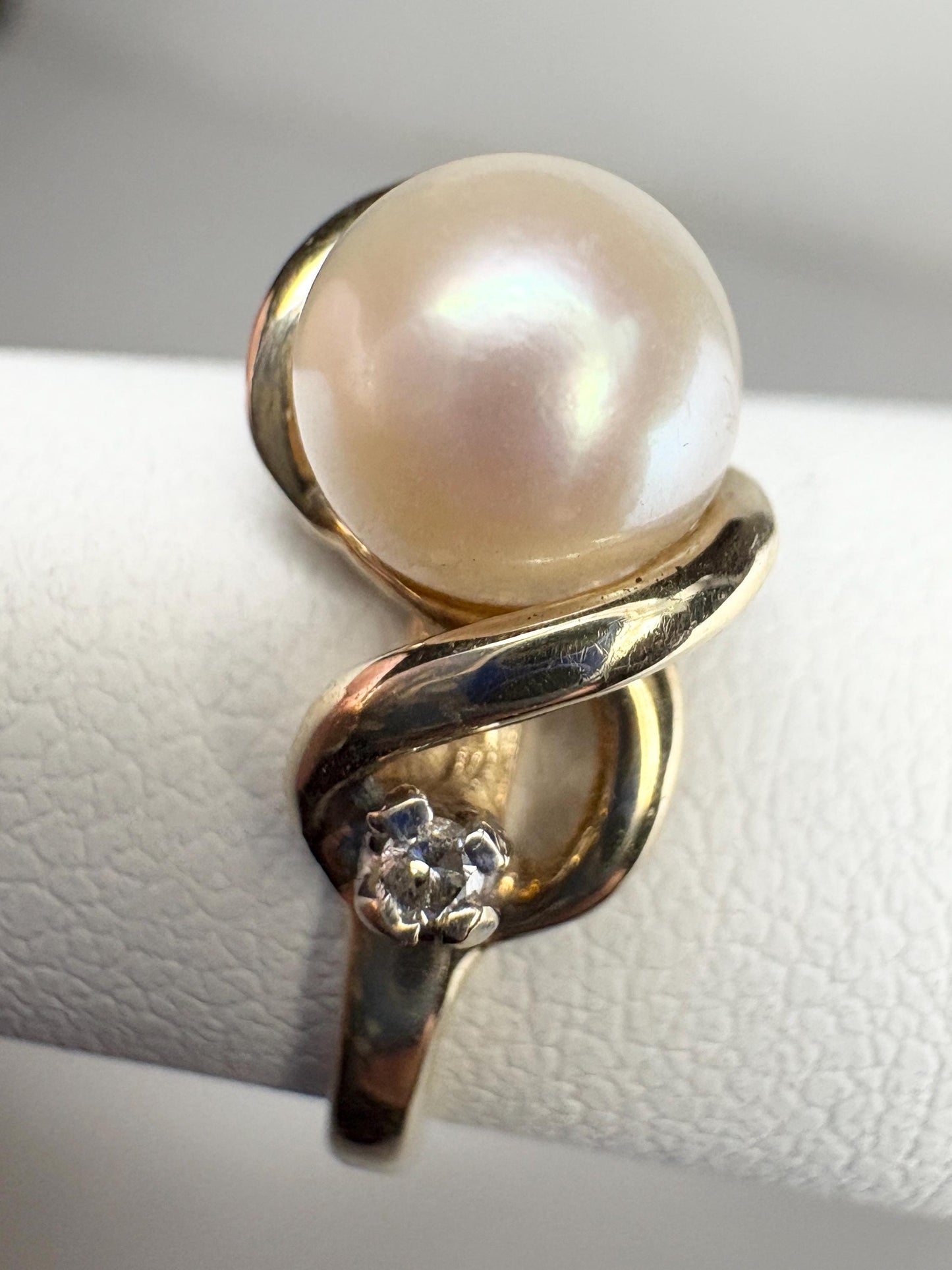 10k gold ring with a pearl and two diamonds.