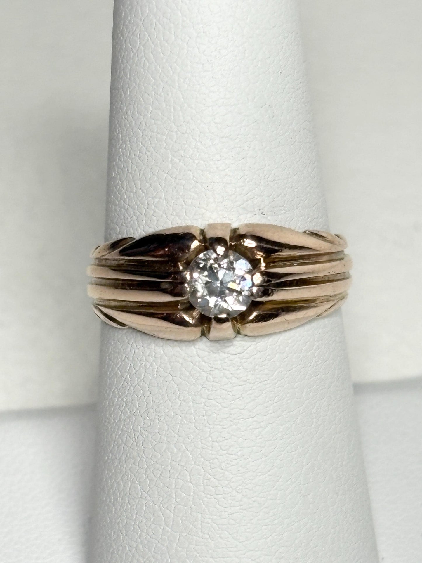 Vintage 10k rose gold ring with an old mine cut diamond on a wide band.