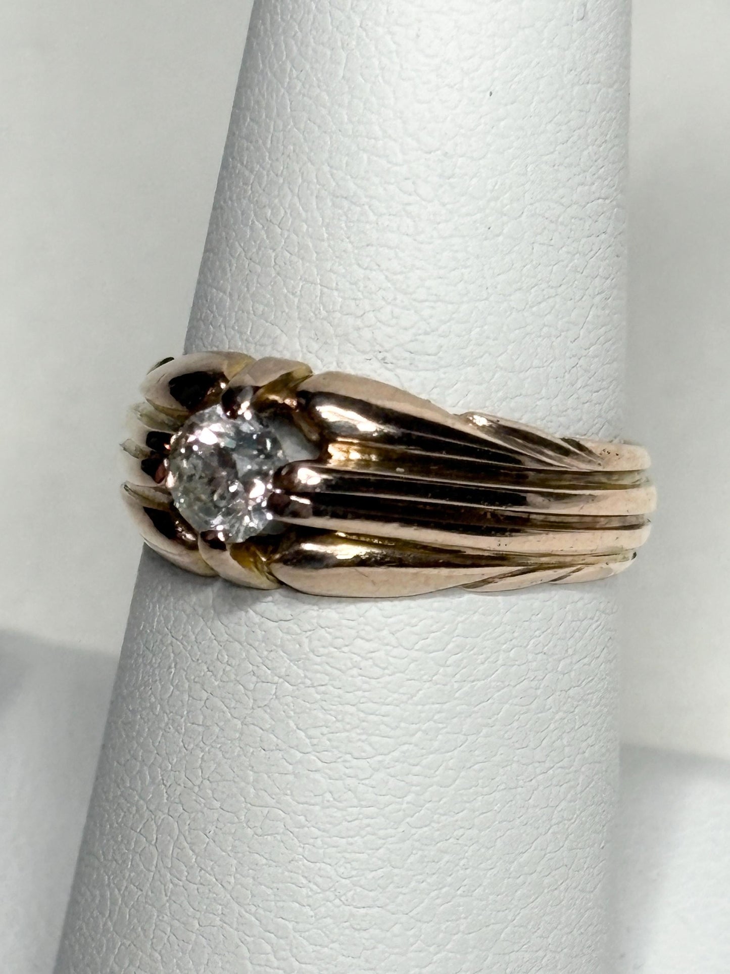 Vintage 10k rose gold ring with an old mine cut diamond on a wide band.