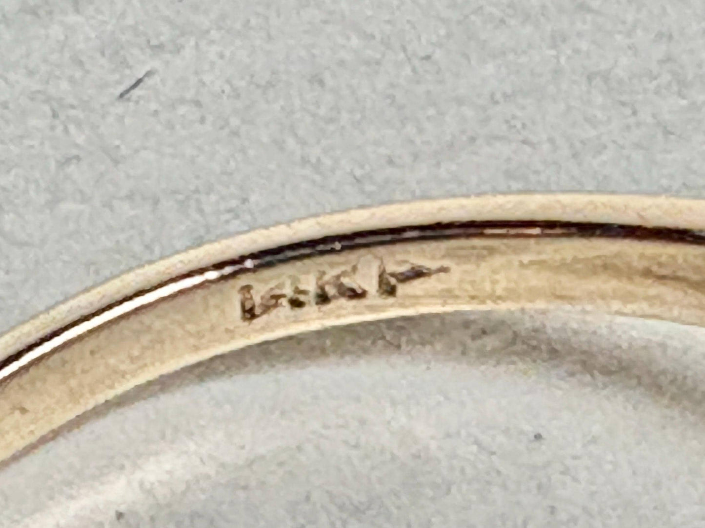 A 14k gold ring with a pink sapphire and diamonds.