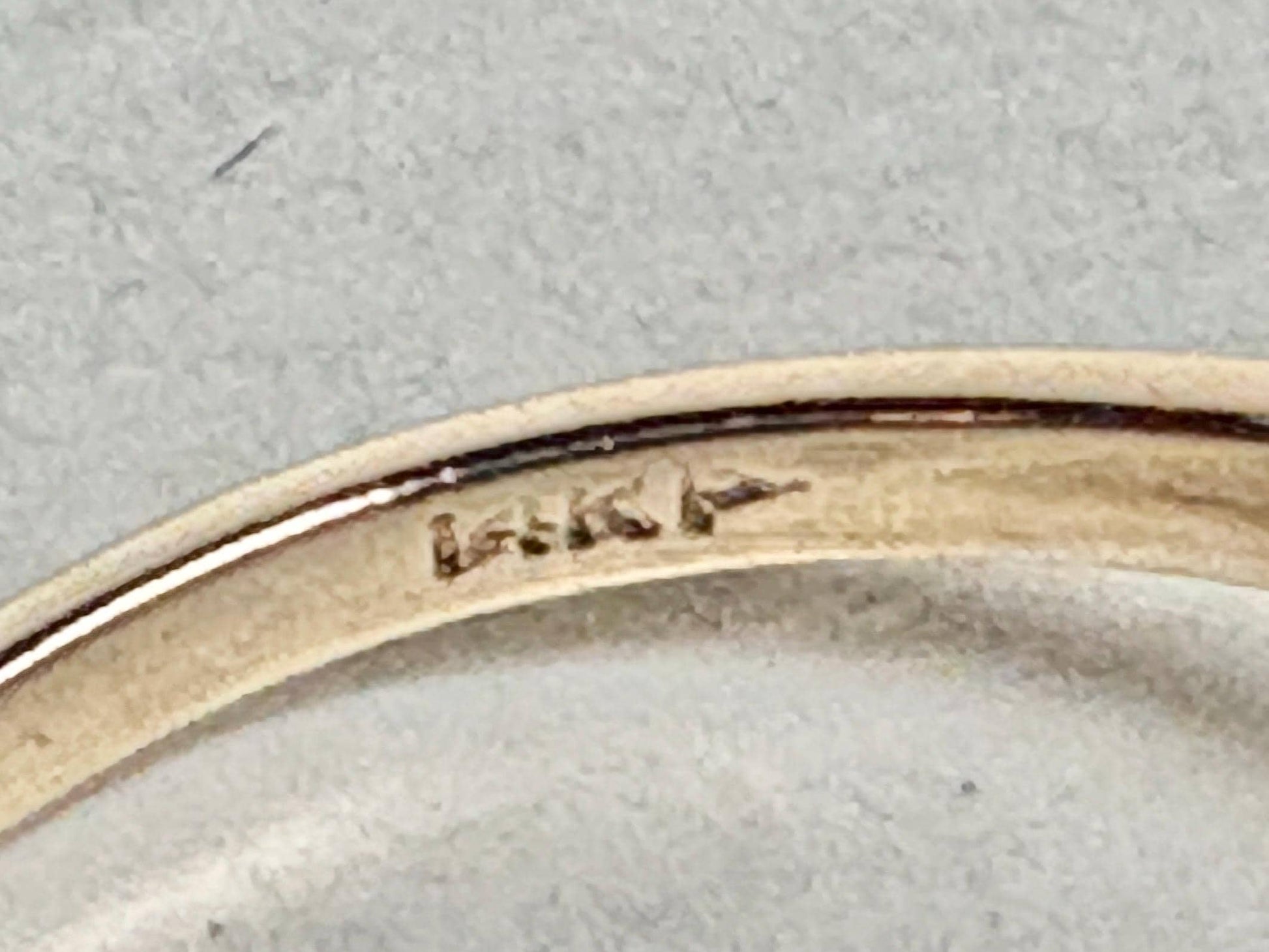 A 14k gold ring with a pink sapphire and diamonds.