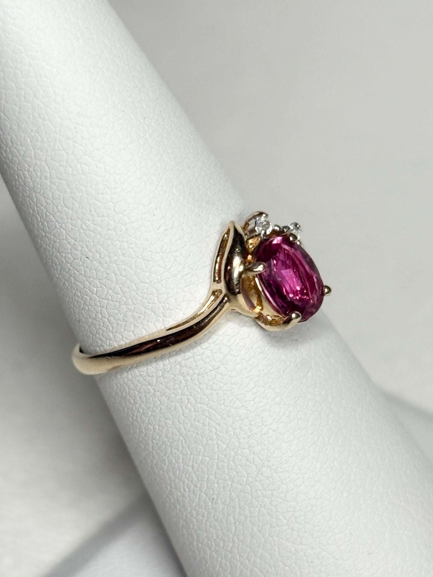 Pink sapphire and diamond ring in 14k gold.