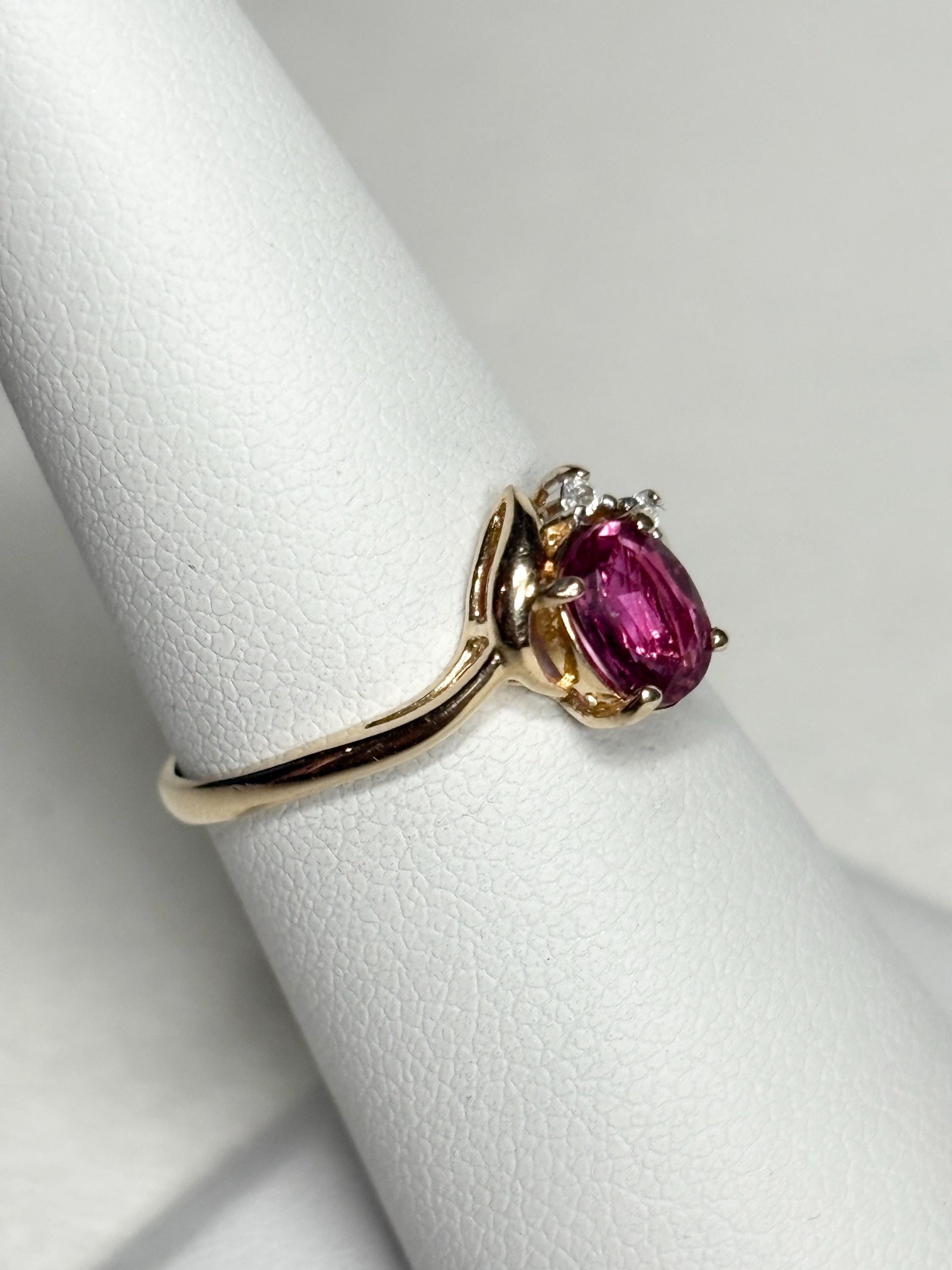 Pink sapphire and diamond ring in 14k gold.