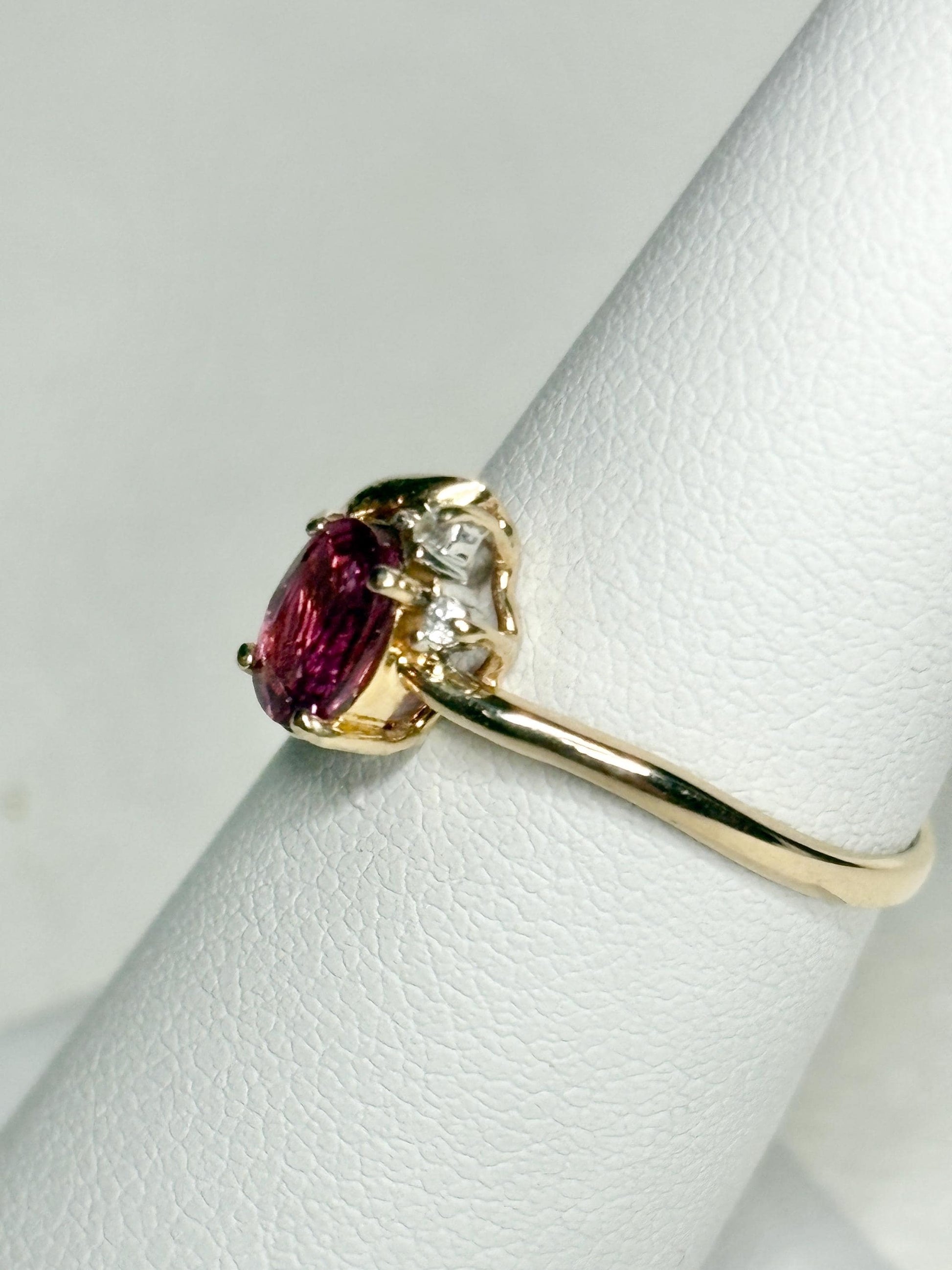 Pink sapphire and diamond ring in solid 14k gold.