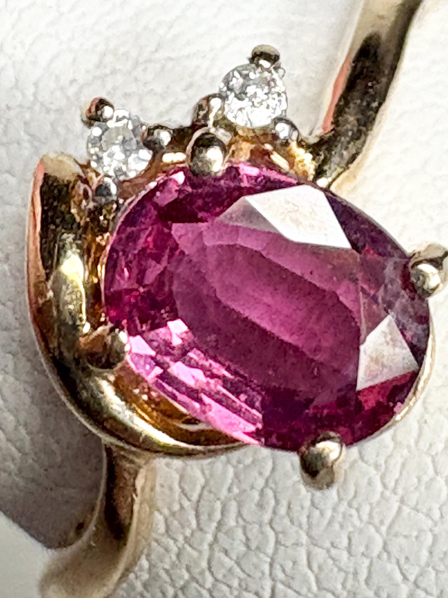 Pink sapphire and diamond ring in 14k gold.