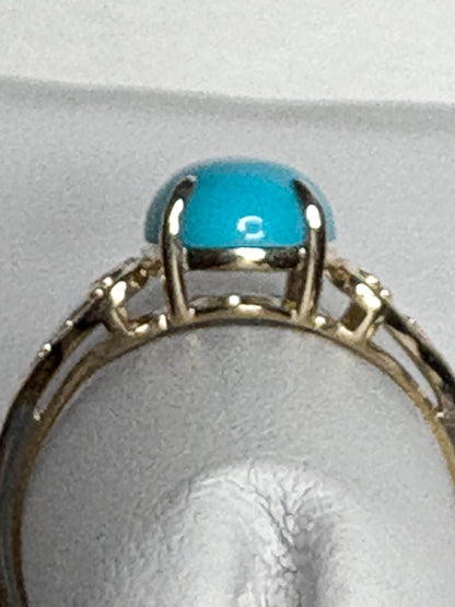 A 10k gold ring with a Sleeping Beauty turquoise stone and small diamonds.