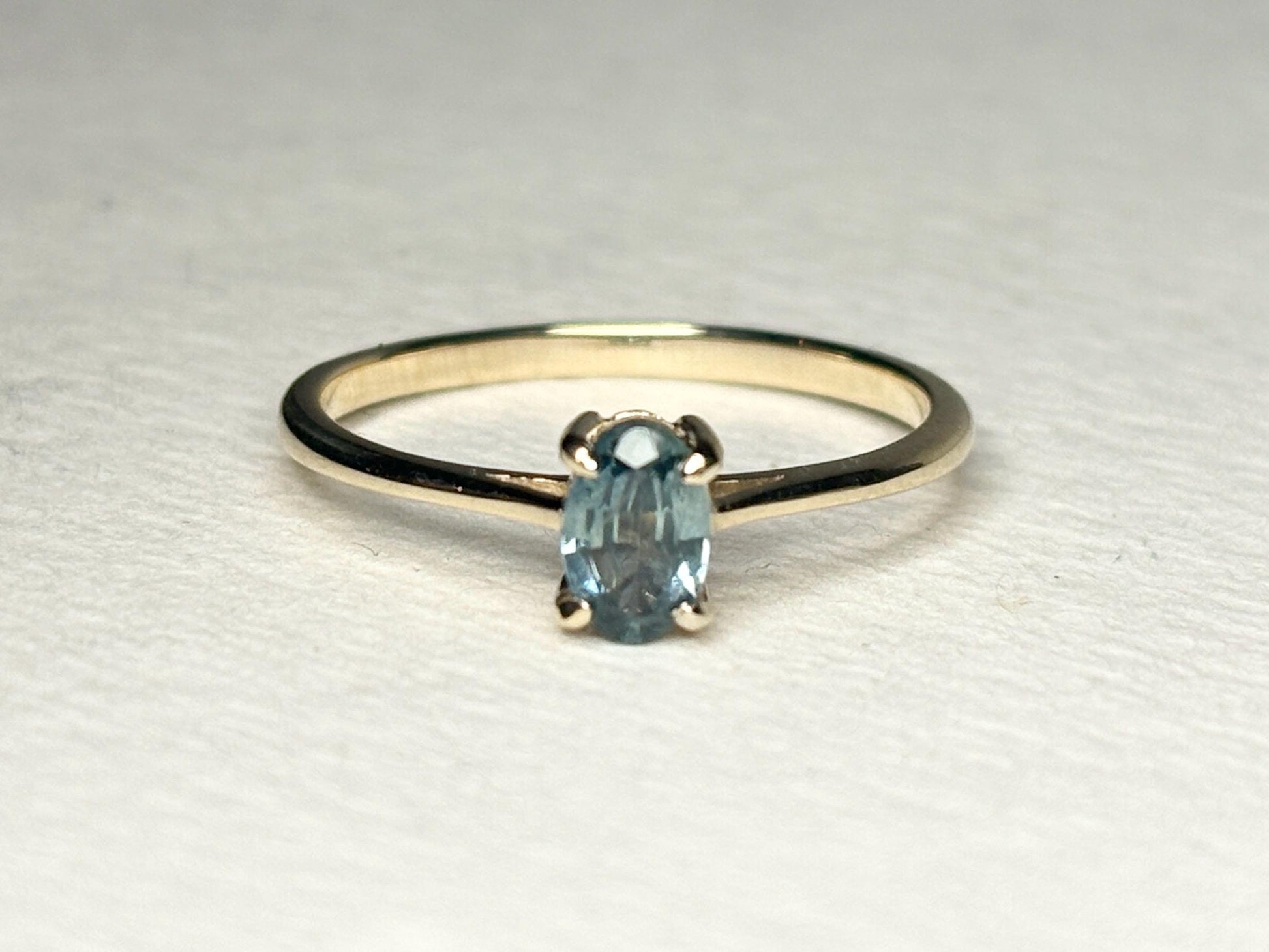 Oval Montana sapphire solitaire ring in solid 10k gold.