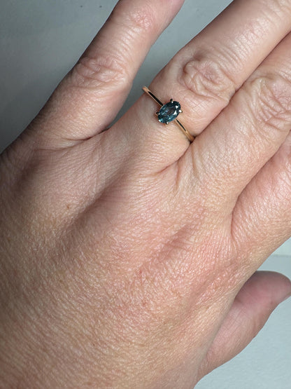 A size 7 ring with a Montana sapphire oval solitaire in 10k gold.