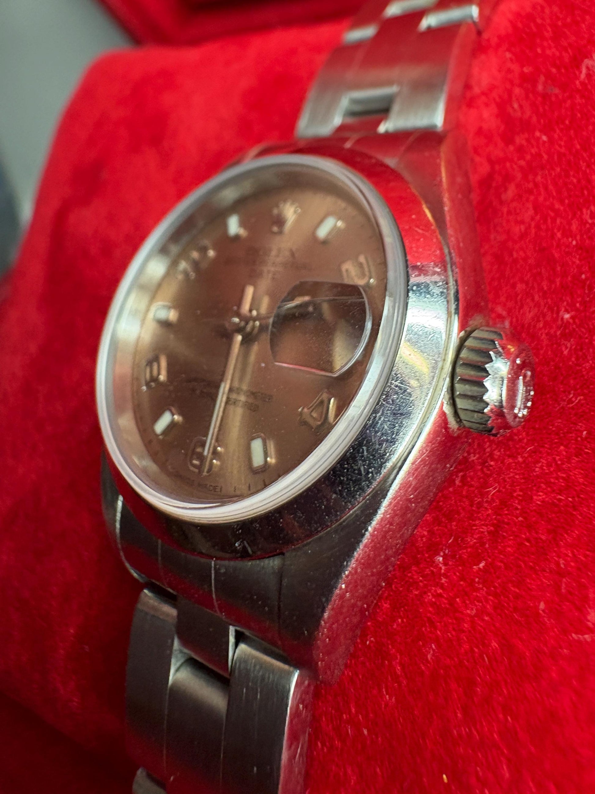Rolex Oyster Perpetual automatic wristwatch with a rose dial and Arabic markers.