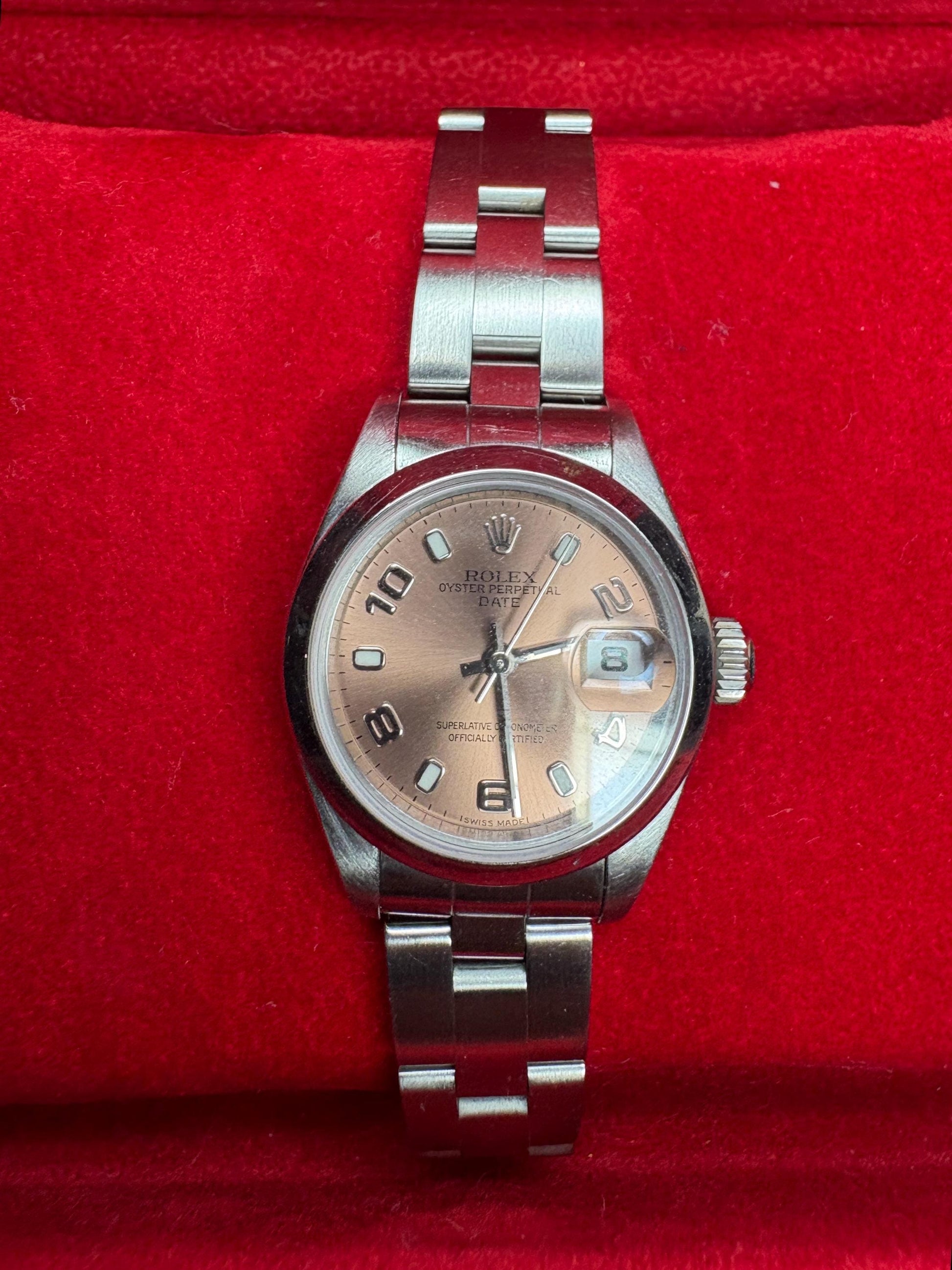 Rolex Oyster Perpetual Date automatic wristwatch with rose dial and Arabic markers.