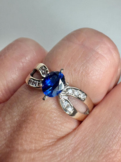 A vivid blue sapphire and diamond ring in 18k white gold.