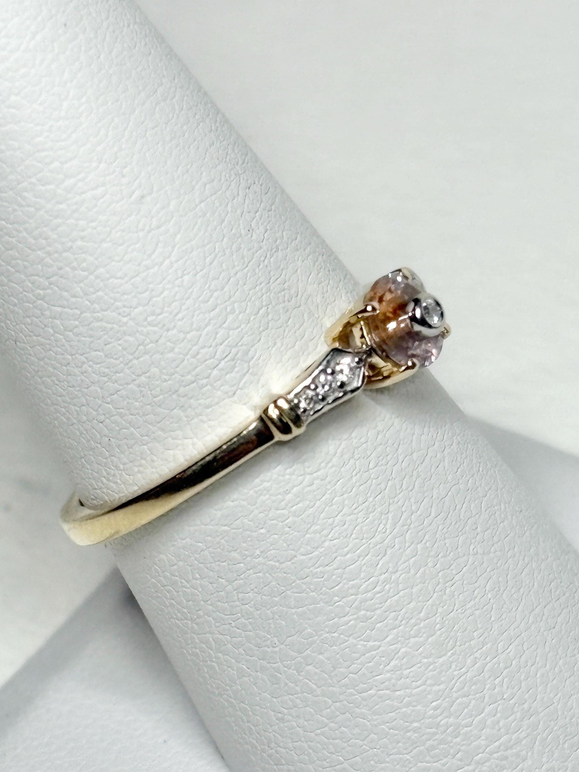 A 9k gold ring with a bi-color Montana sapphire and .07ct diamonds.