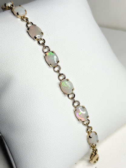 Gold plated bracelet with 11 oval natural Australian opals.
